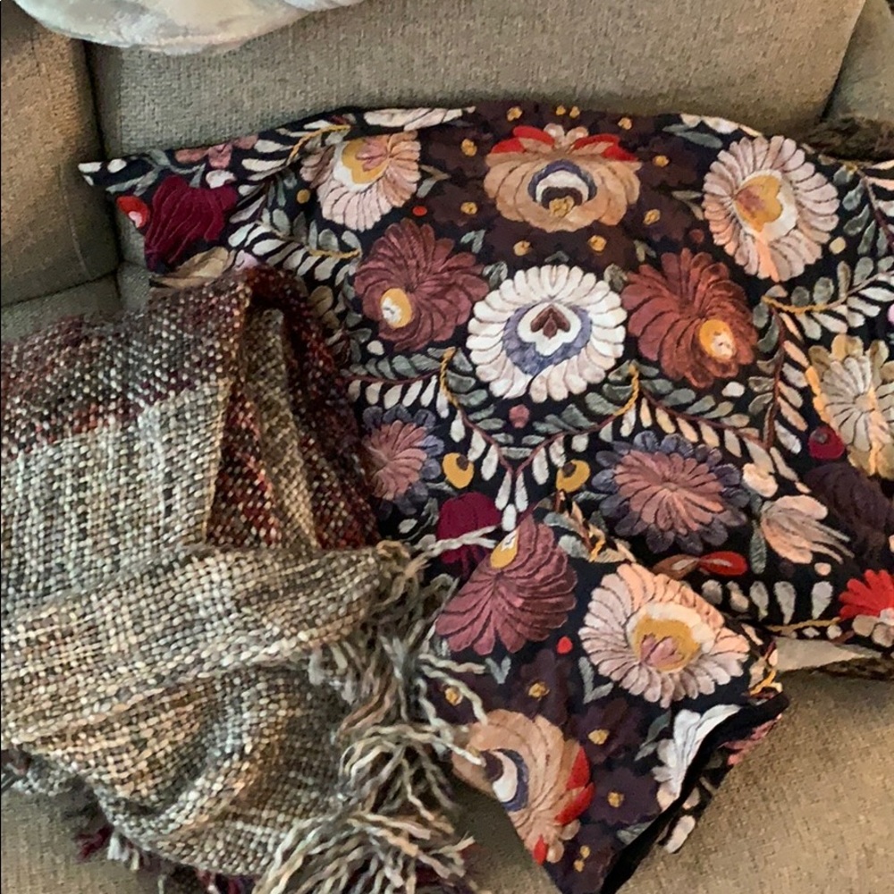 Two pottery barn pillow shams and a blanket